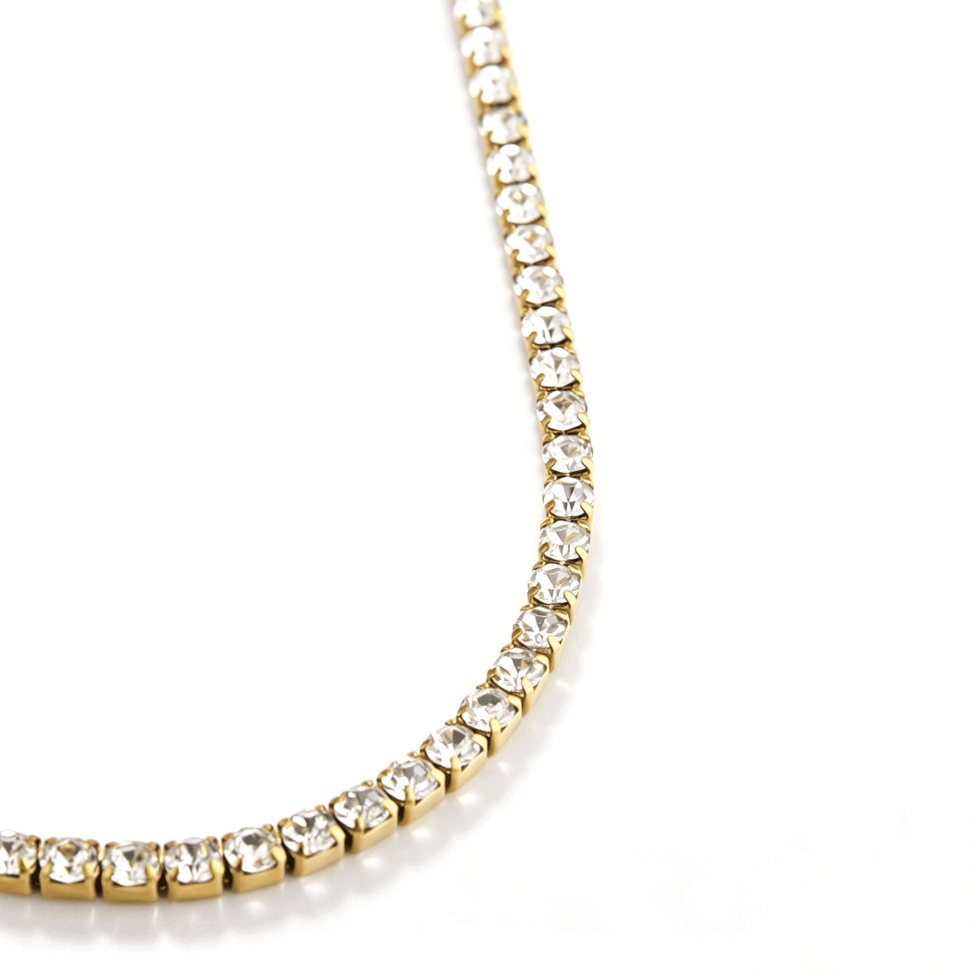 Angled row of clear cubic zirconia stones in gold-tone settings