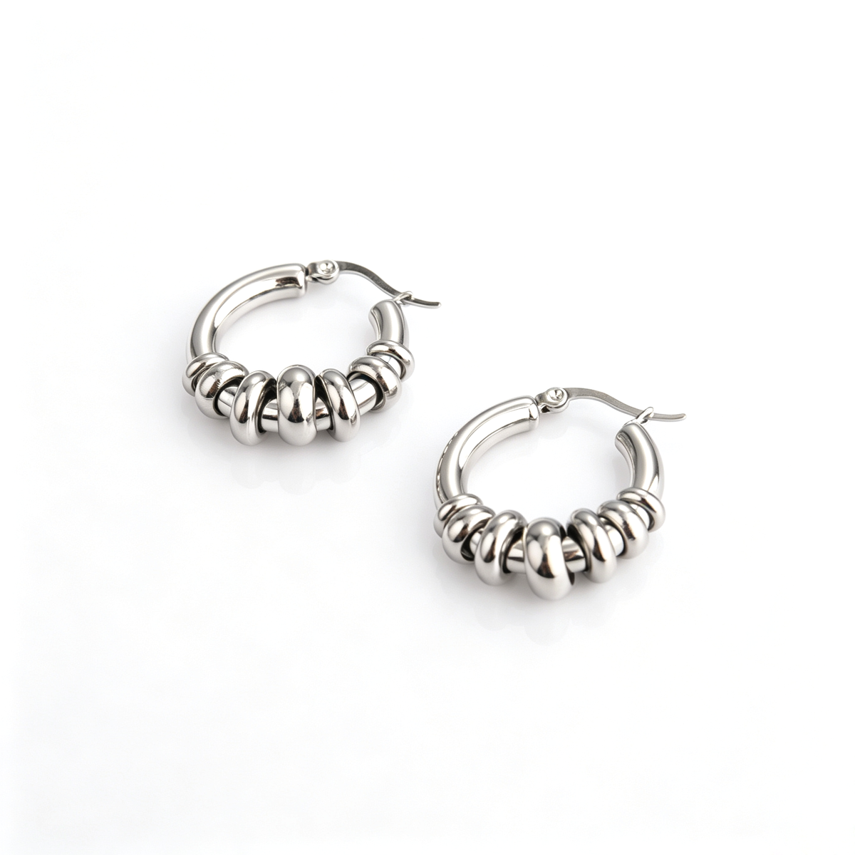 Pair of stainless steel hoop earrings featuring graduating sliding ring beads and latch back clasp.