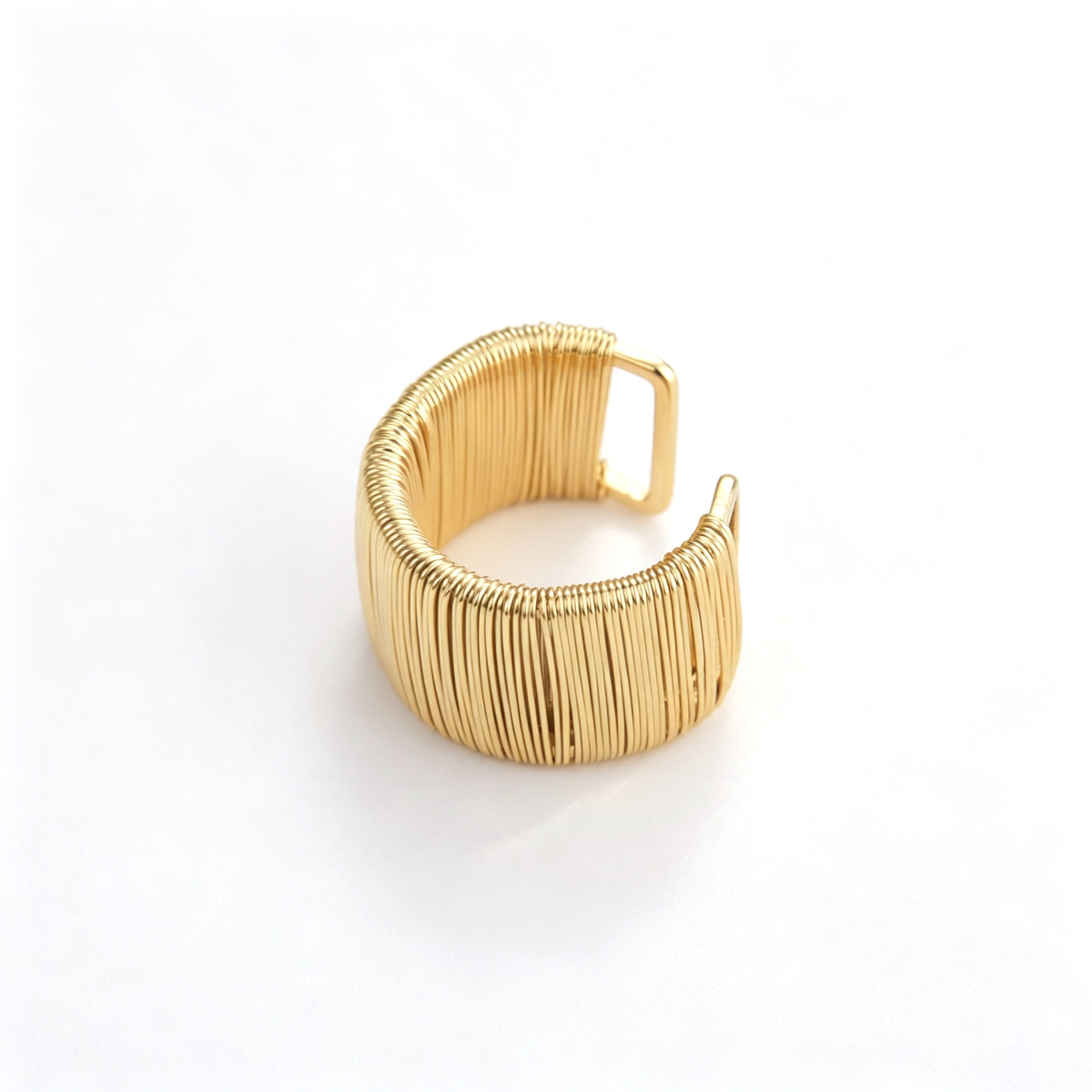 Wide cuff bracelet shown from the front, highlighting the open ends and vertical ribbed texture