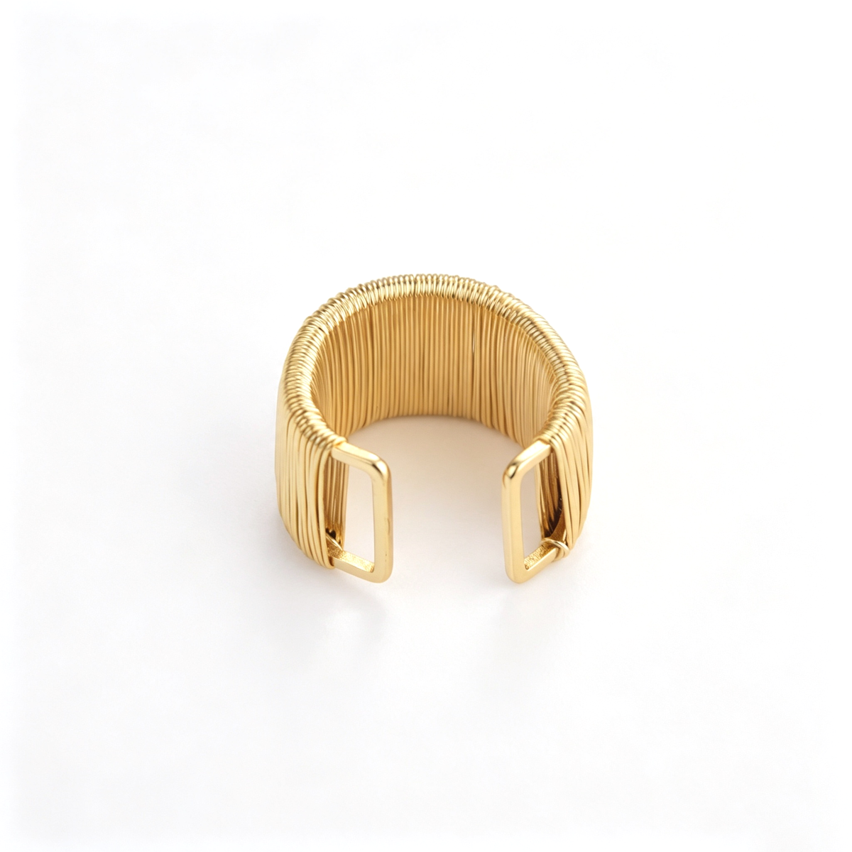 Textured open cuff bracelet viewed from above, showing the curved interior and ribbed band