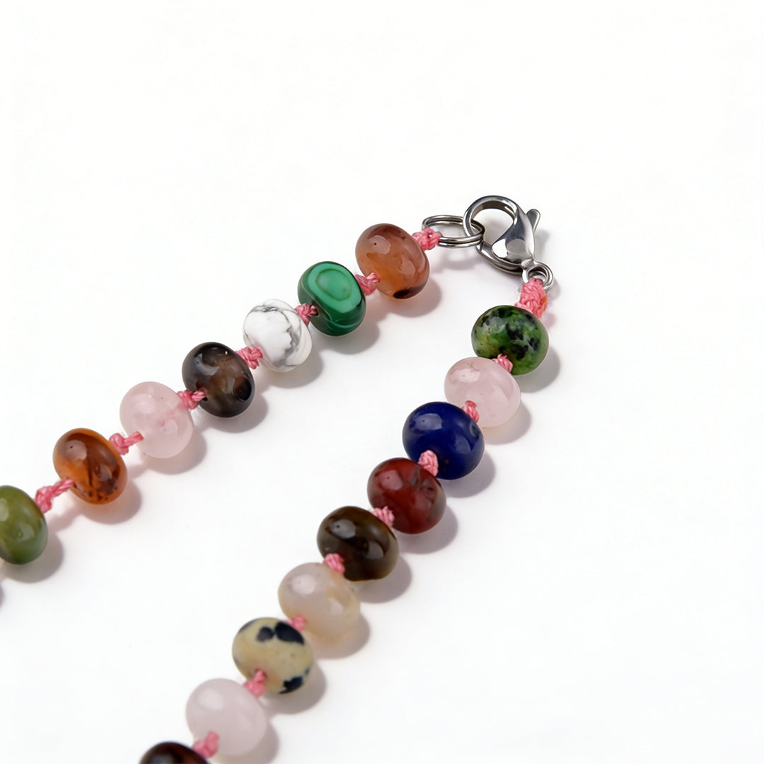Close-up of a triple-layer beaded cuff bracelet showing the vintage copper clasp detail.