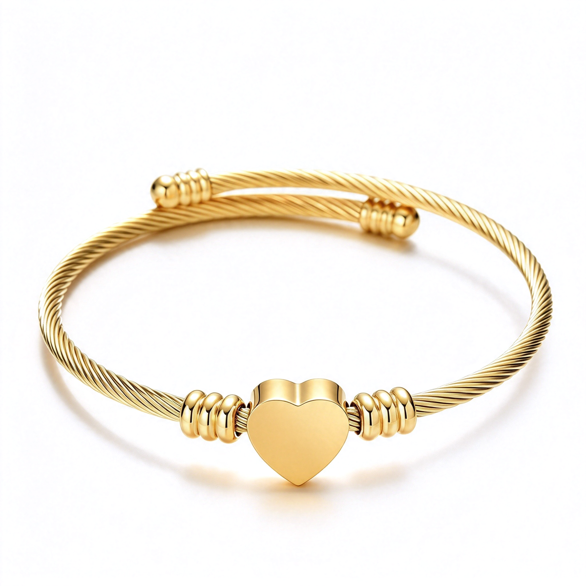 Gold-tone heart open cuff bracelet with a twisted cable band, shown on a white background.
