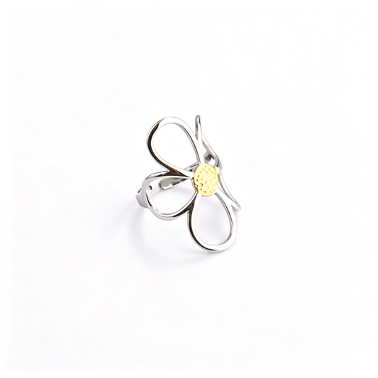 Angled view of a two-tone silver cutout flower open ring featuring a textured gold center pistil.