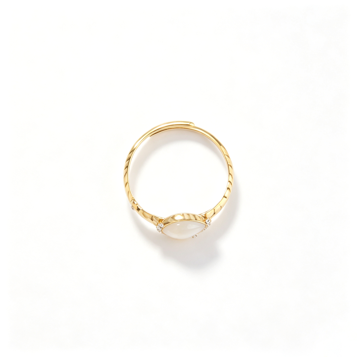 Top-down view of an 18k gold-plated open ring featuring a central opaline stone and cubic zirconia accents.