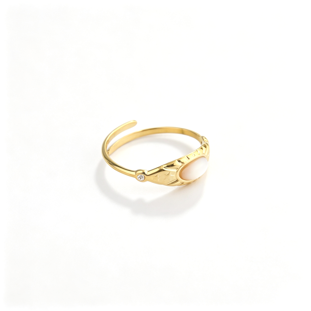 Angled view showcasing the sunburst-engraved gold band and bezel-set marquise opaline stone with CZ studs.