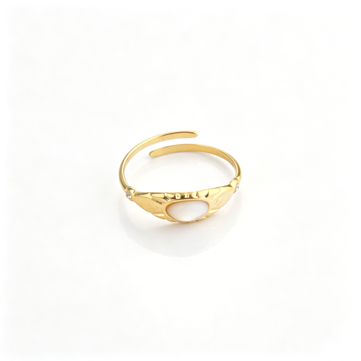 Front perspective of the vintage gold open ring displaying its smooth central oval stone and engraved side details.