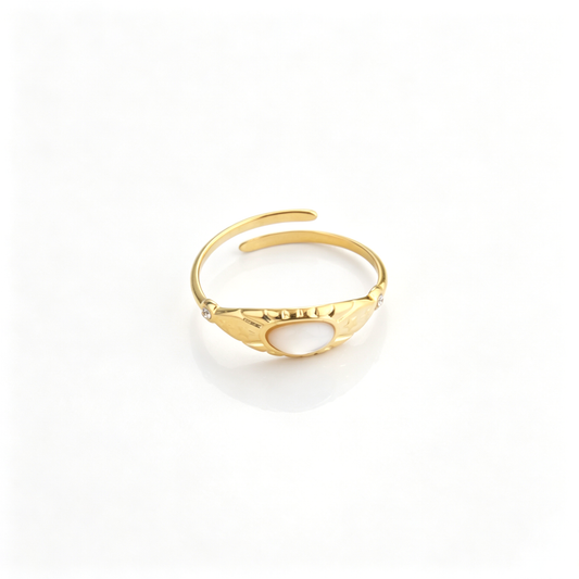 Front perspective of the vintage gold open ring displaying its smooth central oval stone and engraved side details.