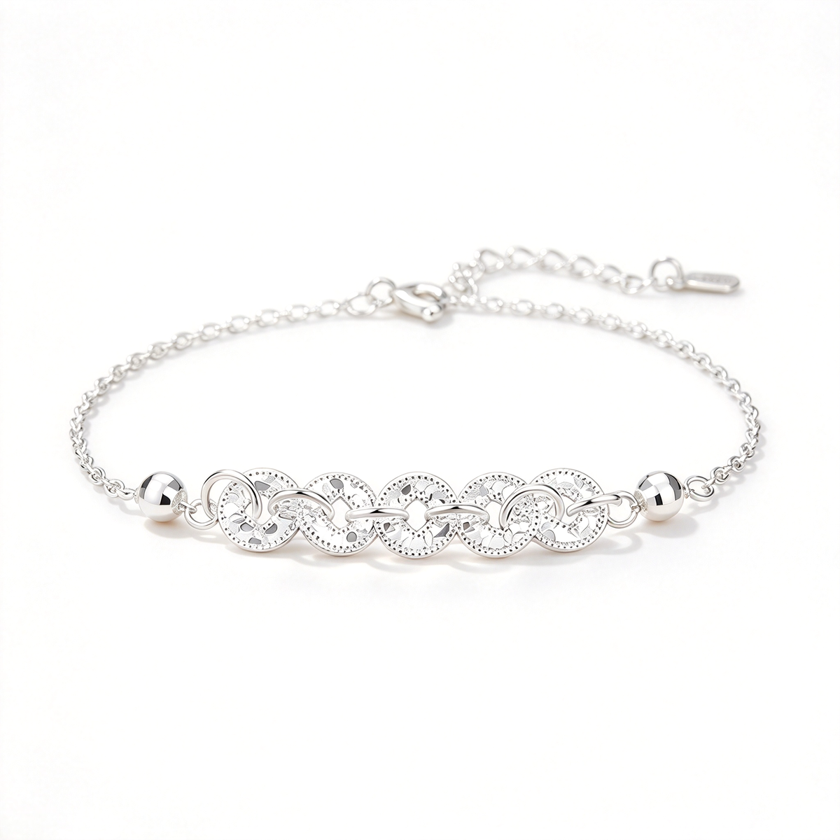 Silver-tone bracelet featuring five linked coin motifs, a fine chain, and an adjustable extension.