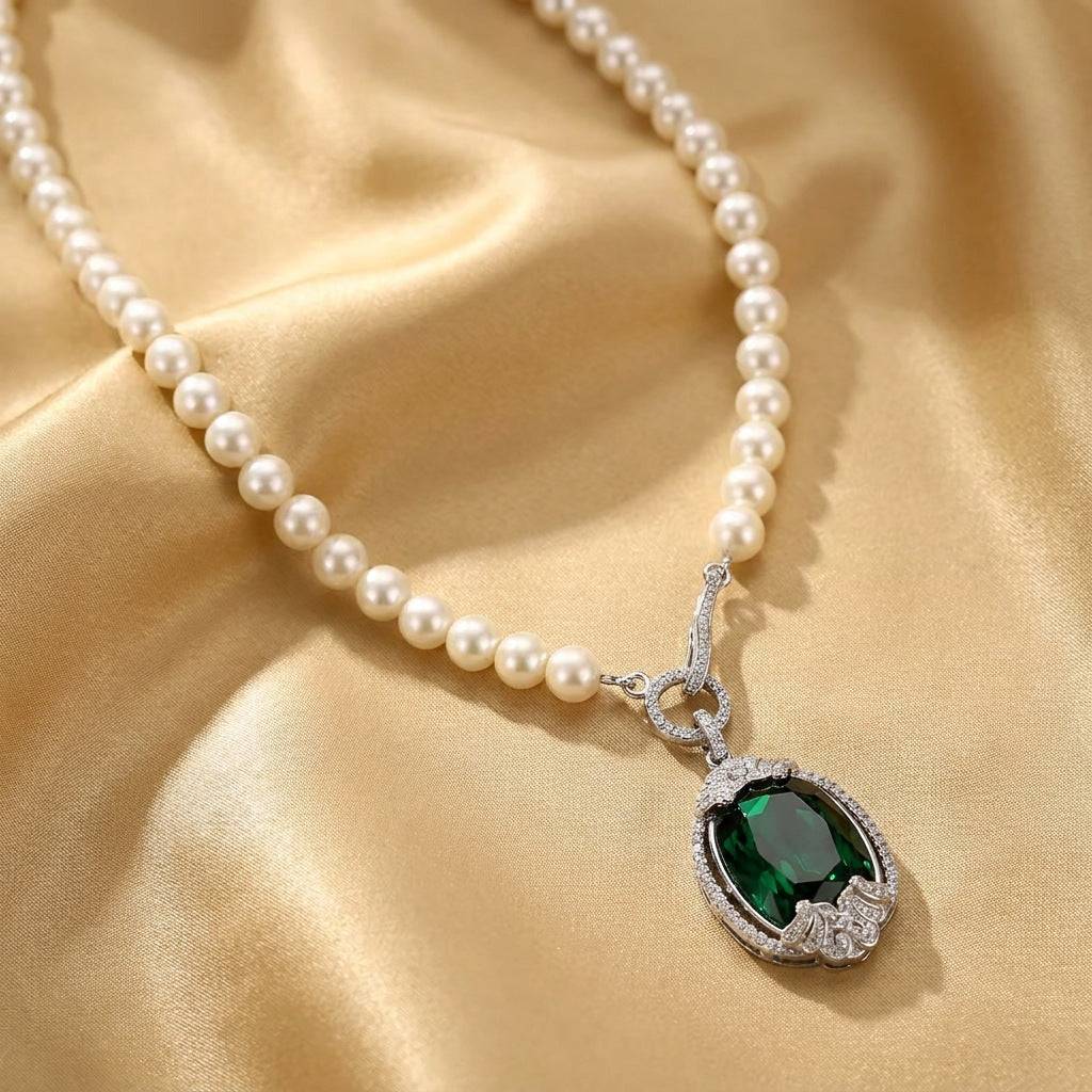 Beautiful angle of the deep green emerald rhinestone crystal pendant resting elegantly on draped champagne silk.