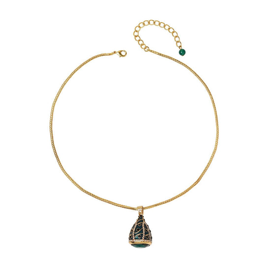 Ever P. vintage emerald style enamel egg pendant hanging on an elegant woven gold wheat chain isolated on white.