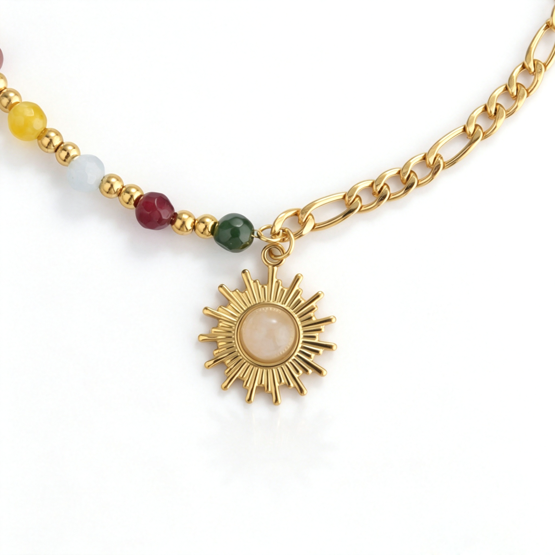 Close-up of the sunburst pendant with cream center, colorful beads, and mixed gold-tone links.