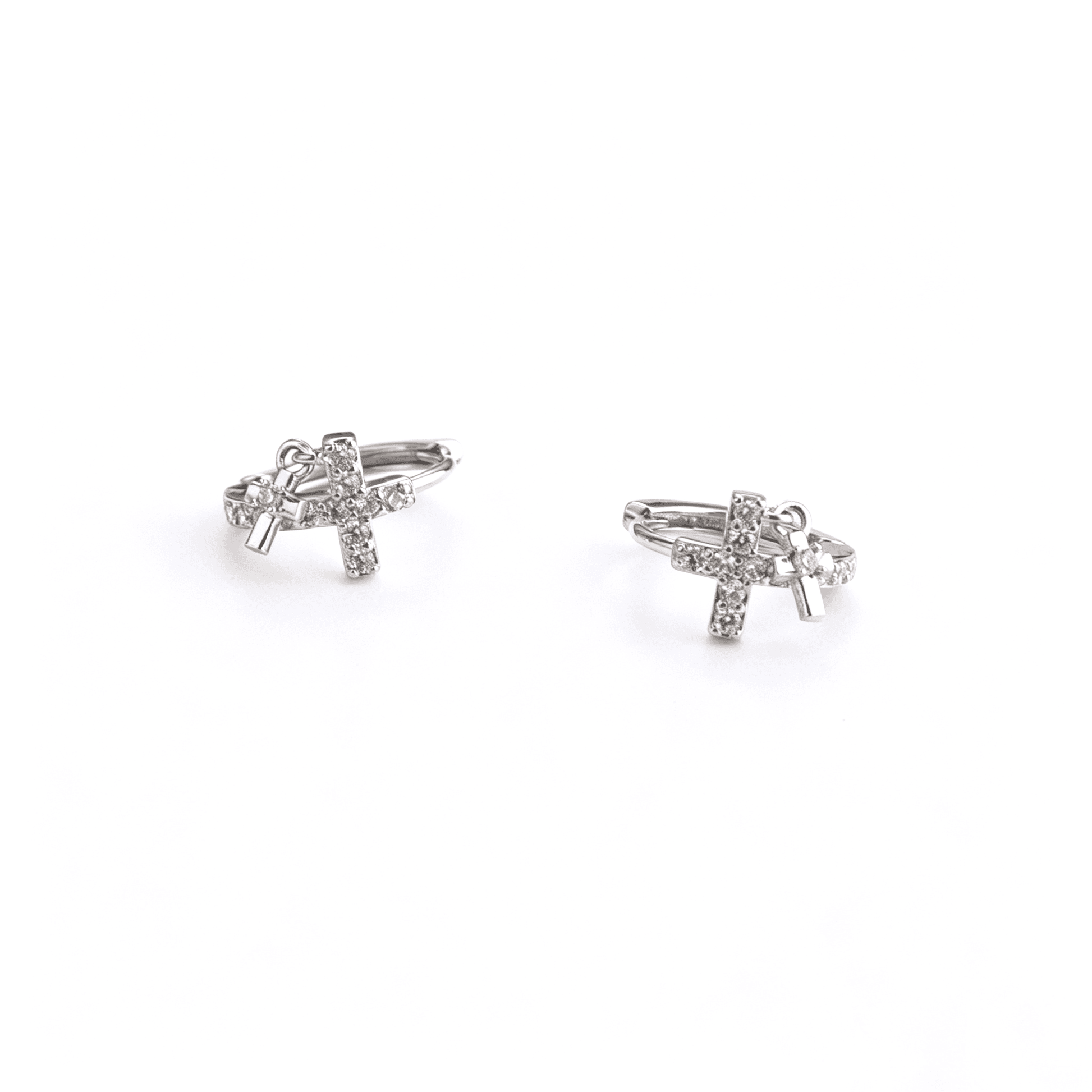 Studio front angle of Ever P. luxury Y2K silver double cross drop charm earrings showcasing their brilliant sparkle.