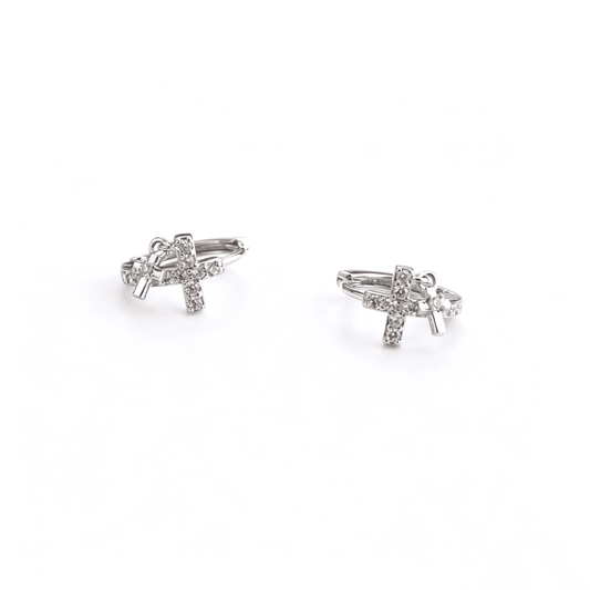 Studio front angle of Ever P. luxury Y2K silver double cross drop charm earrings showcasing their brilliant sparkle.